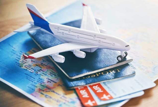 BrandAppMay22 Plane model with world map, passports and tickets as airplane traveling and tickets booking concept